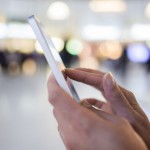 Close up of a woman using mobile smart phone